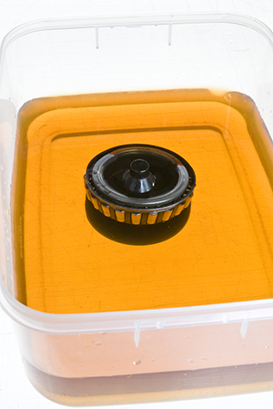 wheel bearing submerged in cleaning fluid